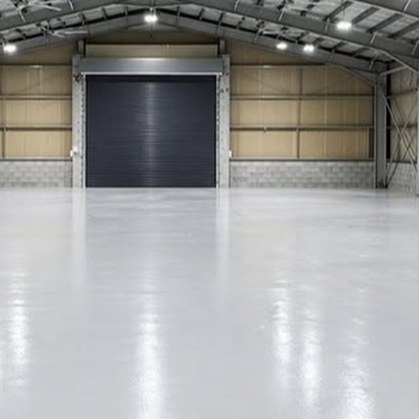 Industrial shed with a coated floor and roller door