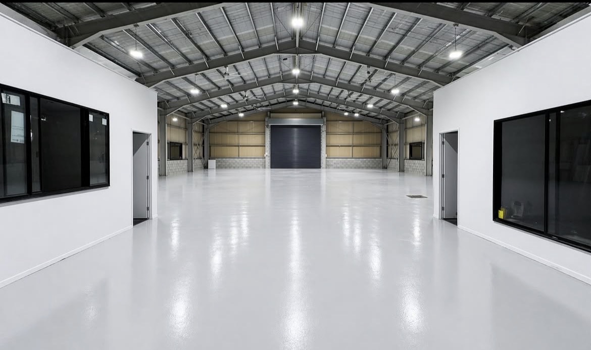 Smooth grey epoxy floor running the length of a Perth shed